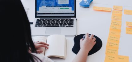 A photo of a woman over 40 happily typing on a laptop at home—cozy and doable.